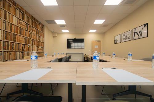 a conference room with two tables with water bottles on them at Nemea Appart Hotel La Boetie Bordeaux Pessac in Pessac