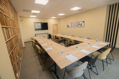 a large conference room with a long table and chairs at Nemea Appart Hotel La Boetie Bordeaux Pessac in Pessac