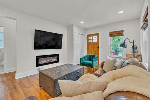 a living room with a couch and a fireplace at The Treehouse at Treetown by Granger Gardens in Ann Arbor