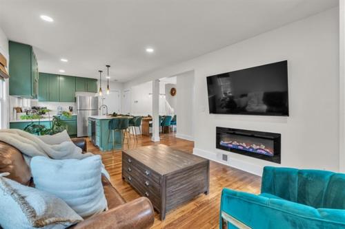 a living room with a couch and a fireplace at The Treehouse at Treetown by Granger Gardens in Ann Arbor
