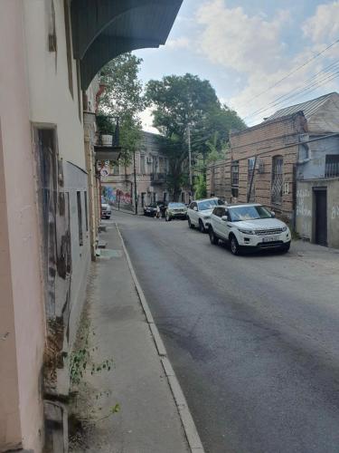 a street with cars parked on the side of a building at Apartment Khizana in Tbilisi City
