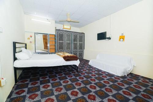 a bedroom with two beds and a rug at farm hosuse beautifull place in Mānsehra
