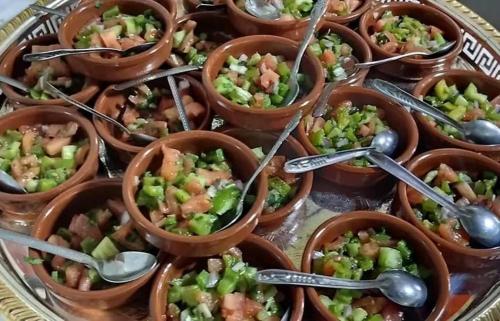 a bunch of cups of food with spoons at Gite Megdaz in Megdaz