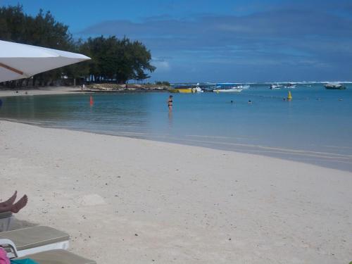 a person standing in the water on a beach at Kaz Resident in Plaine Magnien