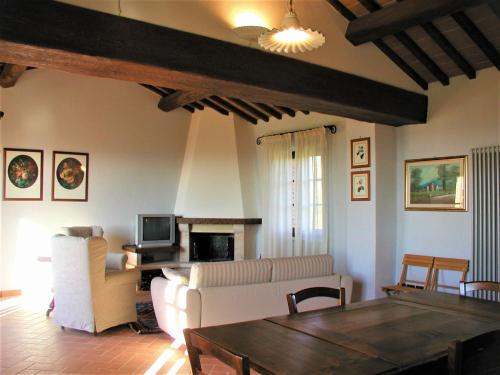 a living room with a couch and a table at Montalceto Tuscan Nest in Serre di Rapolano