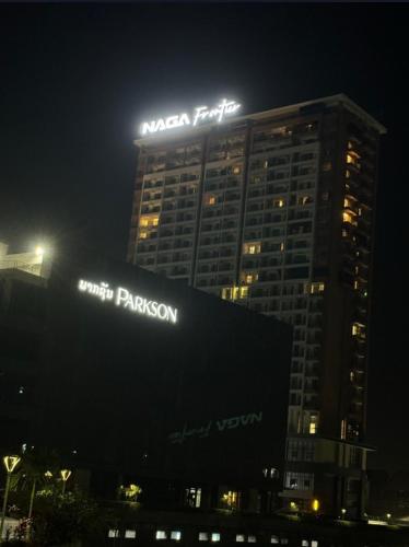 a building with a sign on top of it at night at 方庭酒店 in Vientiane
