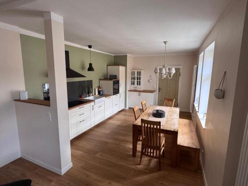 a kitchen with a table and chairs in a room at Ferienhaus Niemtsch -Alte Schule- in Senftenberg