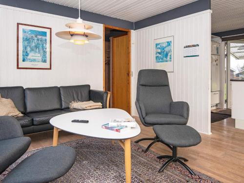 a living room with a couch and two chairs and a table at 5 person holiday home in Odder-By Traum in Odder