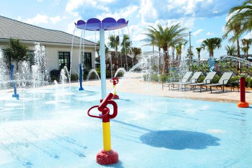 a fountain with a pair of scissors on top of a pool at Five Bedrooms Home with Pool 4851 in Kissimmee