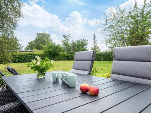 a wooden table with apples on top of it at 5 person holiday home in Odder-By Traum in Odder