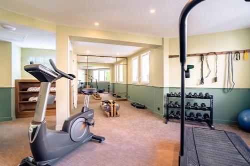a fitness room with a treadmill and a gym at RockyPop Marseille Hôtel in Marseille