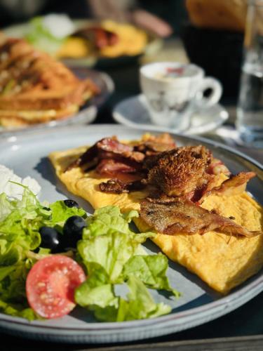 een bord eten met een broodje en salade op een tafel bij Ideal Apartments in Banja Luka