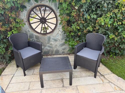 two chairs and a table on a patio at Pension Barborka in Jičín