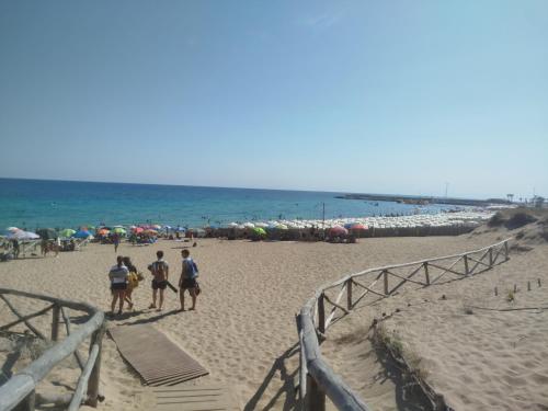 a group of people riding horses on the beach at Casa Acquamarina in Campomarino