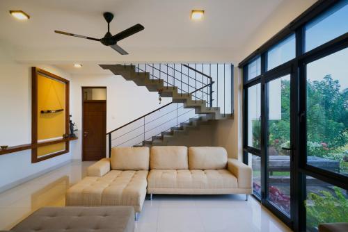 a living room with a couch and a staircase at Polaris- Kurunegala in Kurunegala