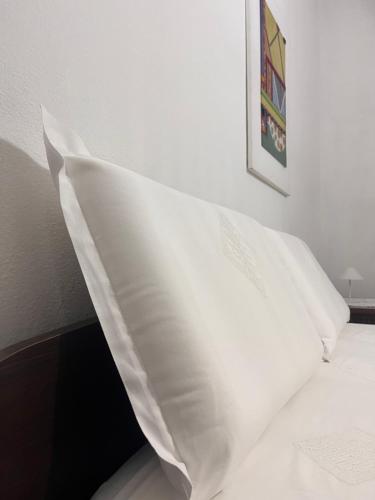 a white pillow sitting on top of a bed at Bed and Breakfast Santu Tomas in Bitti