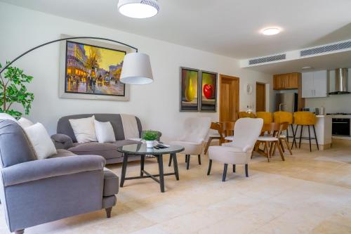 a living room with a couch and chairs and a table at Xeliter Green One Playa Dorada in San Felipe de Puerto Plata