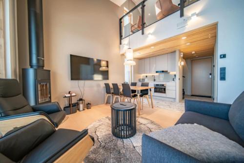 a living room with a couch and a table at Peak Chalet B6 Ski-in Ski-out by Aavalevi in Levi