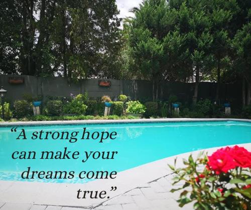 a strong hope dreams come true near a swimming pool at Lamon Guesthouse in Kroonstad