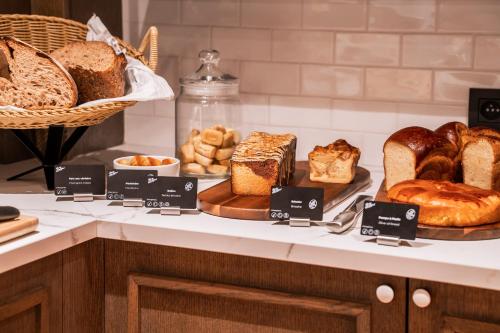 a bakery with different types of bread on a counter at RockyPop Marseille Hôtel in Marseille