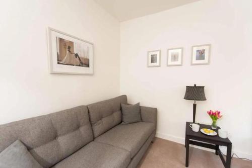 a living room with a couch and a table at Dalziel House-3 bedroom Hamilton in Hamilton