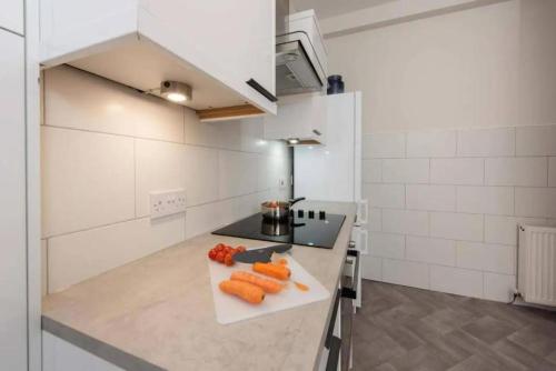 a kitchen with carrots on a cutting board on a counter at Dalziel House-3 bedroom Hamilton in Hamilton