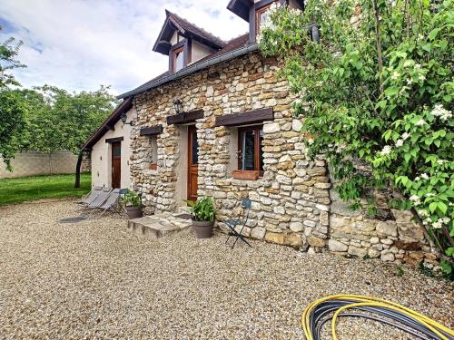 a small stone house with a bench in front of it at Trois logements indépendant au Grande Vigne in Saint-Étienne-sous-Bailleul