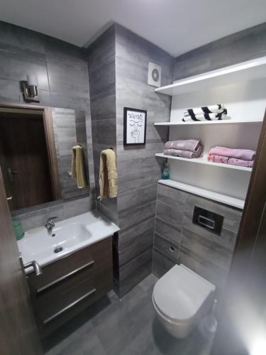 a bathroom with a sink and a toilet at Beachside Apartment in Mohammedia