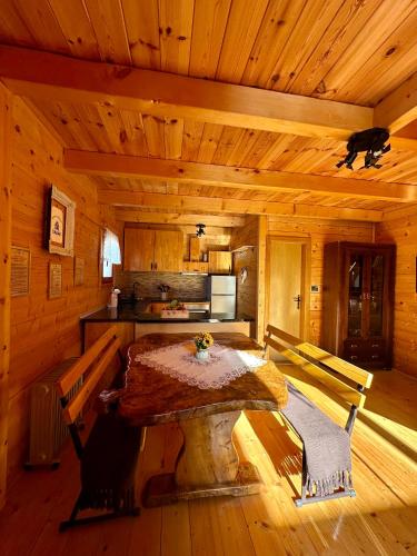 a kitchen with a table in a wooden room at Dabar kuca za odmor in Banja Luka