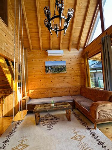 a living room with a couch and a chandelier at Dabar kuca za odmor in Banja Luka