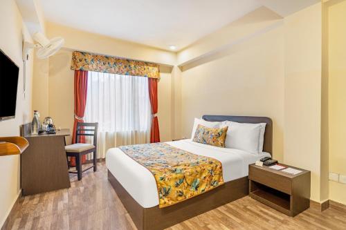 a hotel room with a bed and a window at Summit Namnang Courtyard & Spa Near Mg Marg in Gangtok