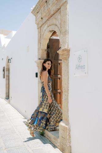 a woman in a dress standing outside a door at Althea Villa in Lindos