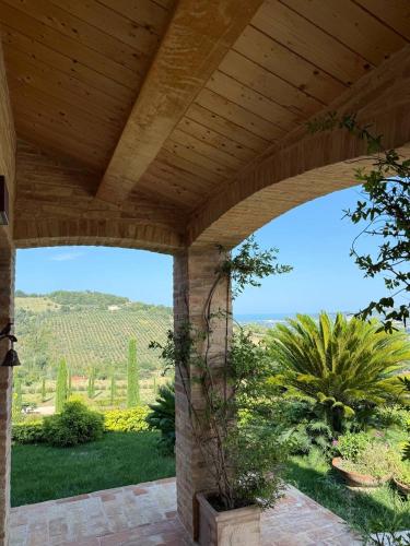 a wooden pergola with a view of a garden at Sole in Moresco