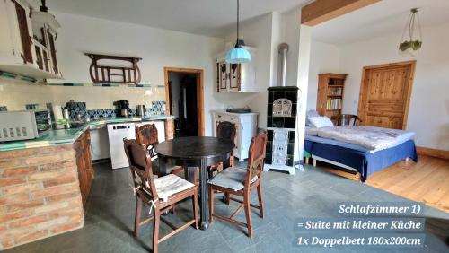 a kitchen and living room with a table and a bed at Scheunenloft Usedom -3- Familienoase bis 6 Pax spacious big garden dog-friendly - SiLyVi homes in Mellenthin