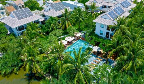 an aerial view of a resort with a pool and palm trees at Hoi An Eco Lodge & Spa in Hoi An