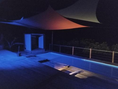 a house with a swimming pool at night at Villa F&B in Bocas del Toro