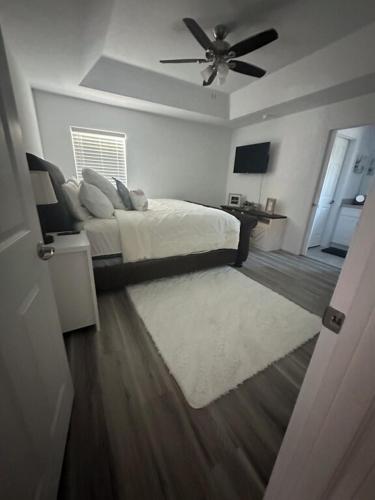 a bedroom with a bed and a ceiling fan at 3 Bed 2 Bath Sleeps 6 Pool Retreat in Eustis, FL!!! in Eustis