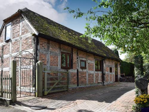 an old brick building with a gate at The Cider Press in Welland