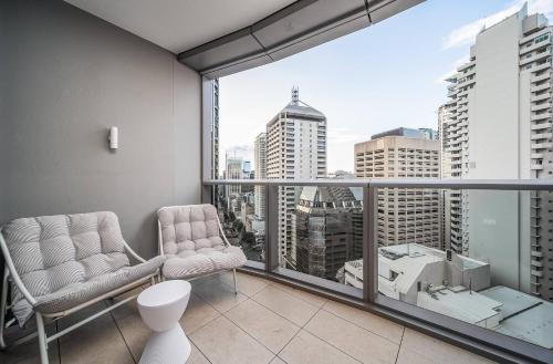 a living room with a view of a city at Skyscraper Cinema - Dream a thousand city lights in Brisbane