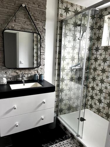 a bathroom with a sink and a shower at Fécamp Beachfront House in Fécamp