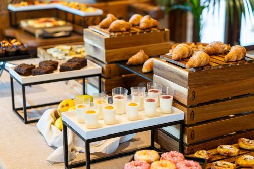 a buffet of pastries and breads on display at Hotel Querceto Wellness & Spa - Garda Lake Collection in Malcesine
