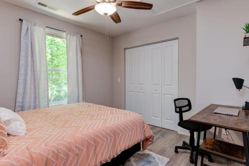 a bedroom with a bed and a desk and a window at Rustic Chic Mountain Home 15 min from DT Asheville in Fletcher