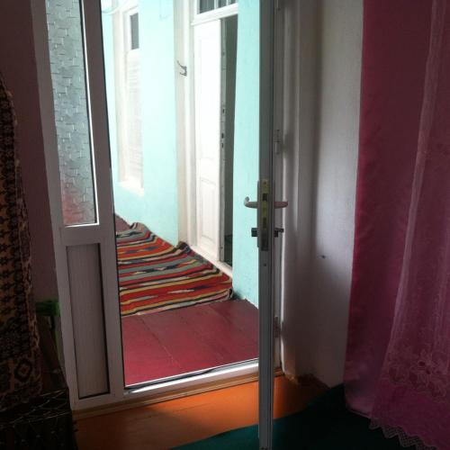 a door leading into a room with a hallway at Ilgar's Hostel in Sheki