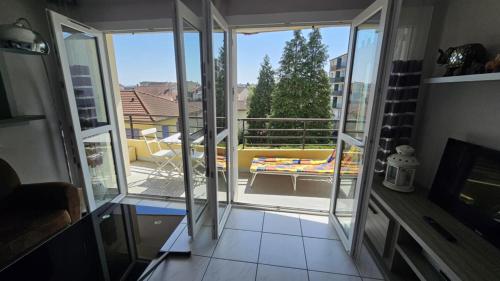 a room with a view of a balcony with sliding glass doors at Balcon en ville in La Celle-sous-Gouzon