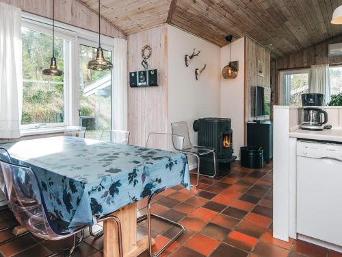 a kitchen with a table with a blue table cloth on it at 8 person holiday home in Ebeltoft in Ebeltoft