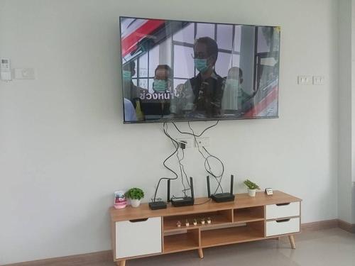 a tv sitting on top of a dresser in a room at Emmaree Villa in Ban Chong Phli