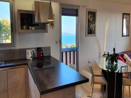 a kitchen with a counter top and a table with a view at Apartment in Nice with Sea Views in Nice
