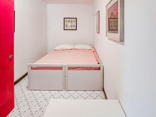 a bedroom with a bed in a white room at Tuscany Villa with Terrace in Ansedónia