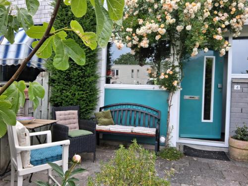 a patio with two chairs and a bench at House nearby Amsterdam in Almere