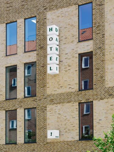 a brick building with a sign on the side of it at Dahei Apartment Hotel in Copenhagen